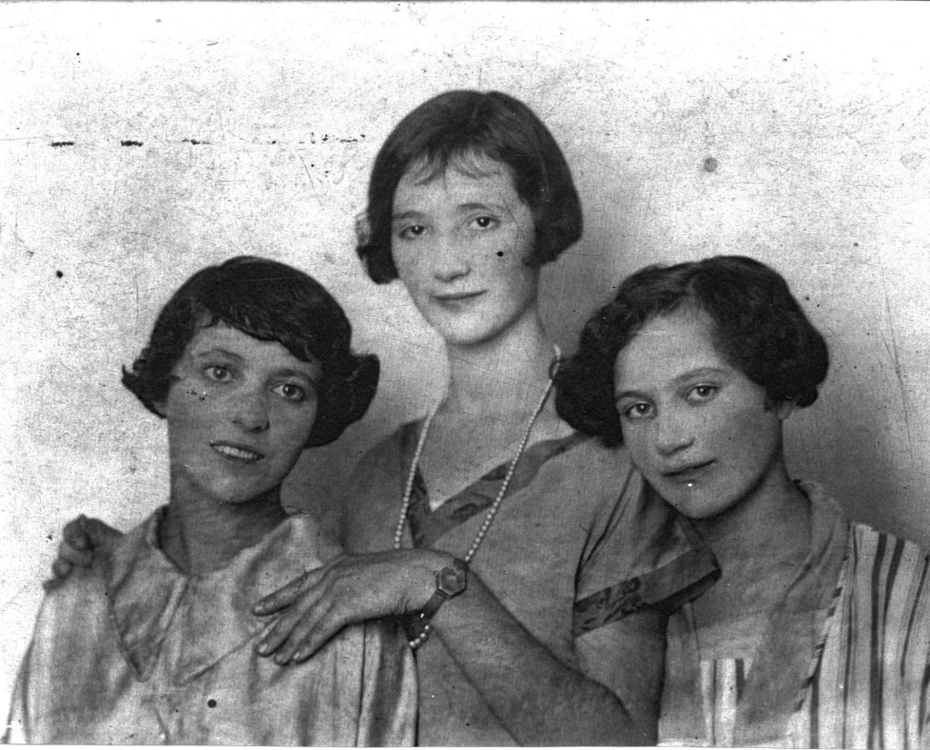 Three young women with old-fashioned styles.