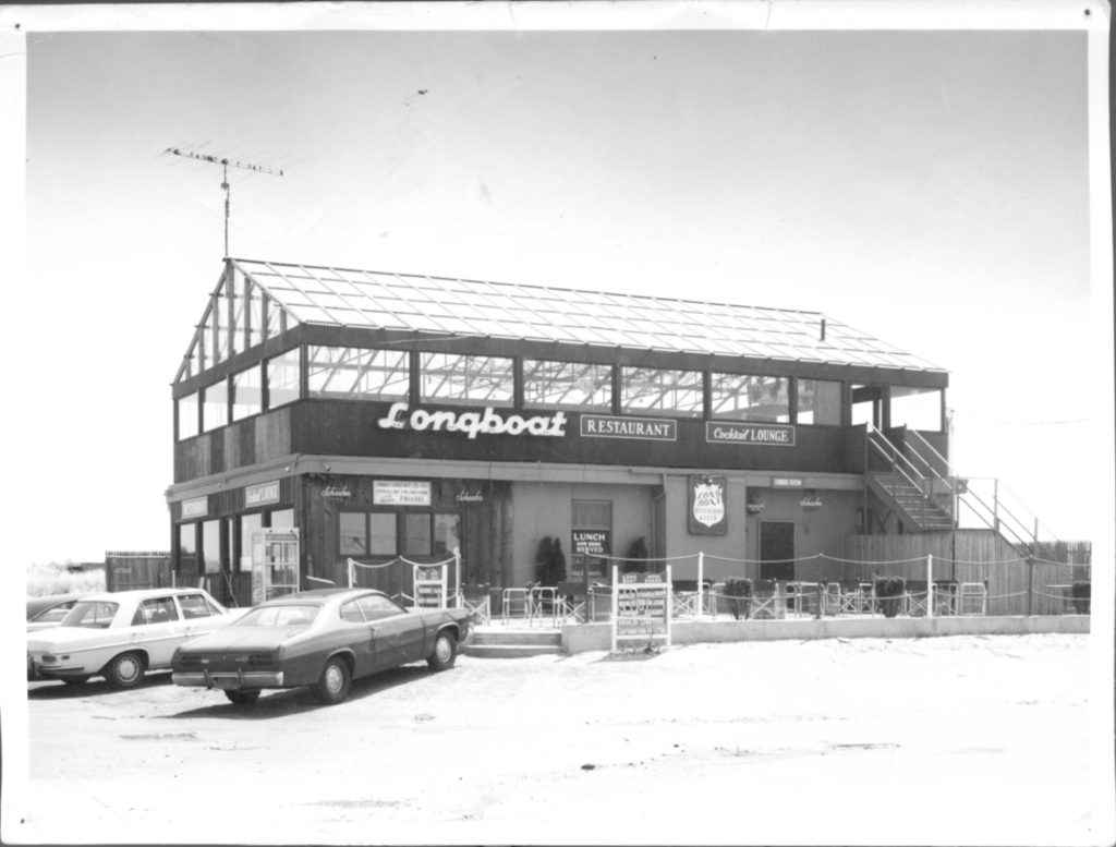 Bar and restaurant, circa 1970s, with outdoor seating, glass rooftop.
