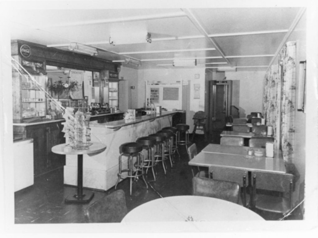 1950s-era luncheonette with stools and tables.