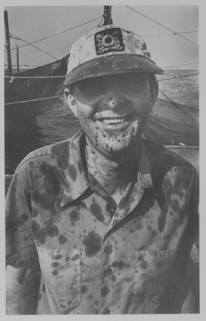 A longtime trap fisherman and champion of baymen’s rights who lived in Amagansett, Stuart Vorpahl spent much of his time as a child with his family working in Montauk. Here he is covered in squid ink while fishing in 1981, most likely at Waterfence or Napeague. | Dan Budnik Photo, Montauk Library Archives