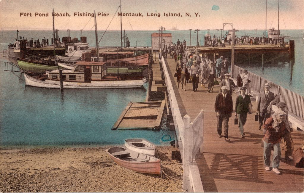 Pier with people walking in suits and hats.